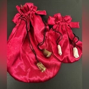 Pink/red satin drawstring pouches.